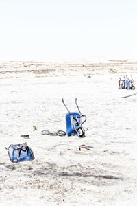 Deck chairs on beach against clear sky