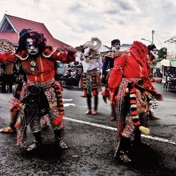 People in traditional clothing against sky