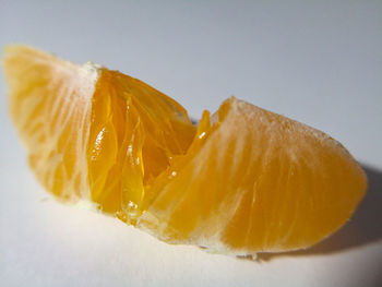 Close-up of orange slice against white background