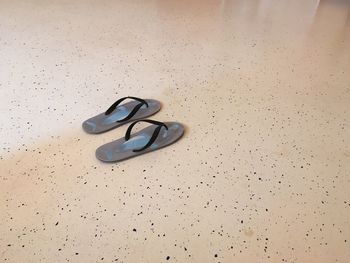 High angle view of flip-flops on floor