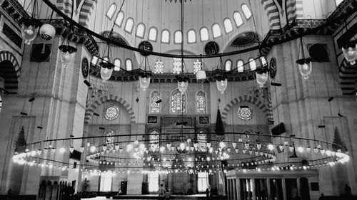 Low angle view of illuminated chandelier hanging in building
