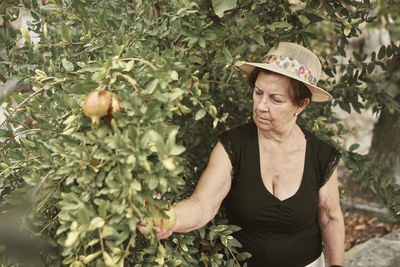 Midsection of woman with plants in park