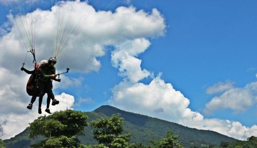 Low angle view of mountain against cloudy sky