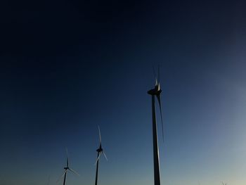 Low angle view of silhouette windmill against sky