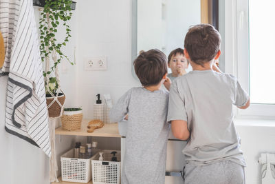 Rear view of couple standing in bathroom