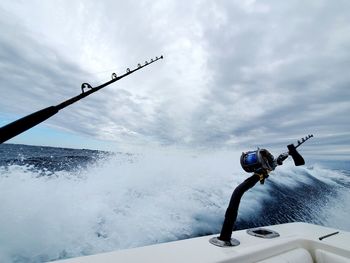 Helicopter in sea against sky during winter