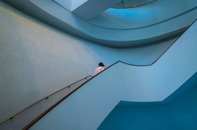 Low angle view of man moving up staircase