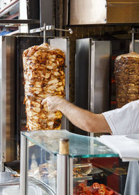 Close-up of man preparing food in store