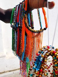 Low section of woman with multi colored umbrellas