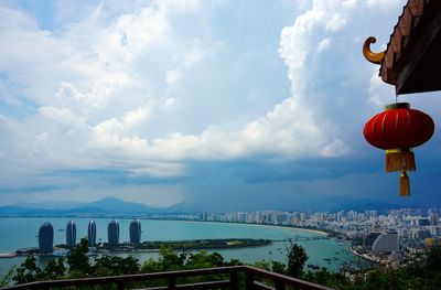 Panoramic shot of buildings by sea against sky