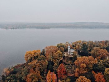 High angle view of trees and sea against sky