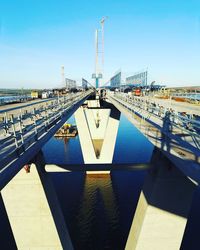 Bridge over river against clear blue sky
