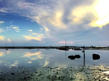 Scenic view of calm sea against cloudy sky