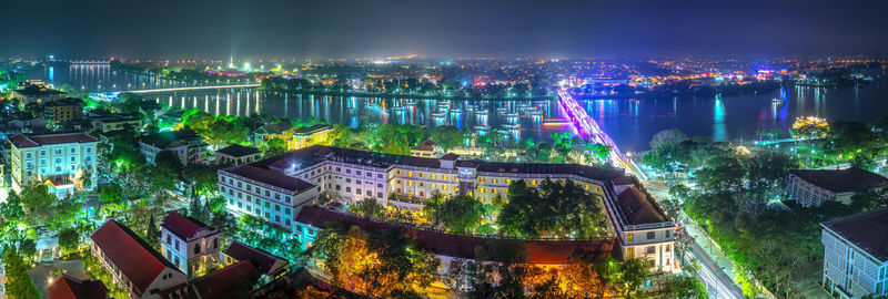 High angle view of city lit up at night