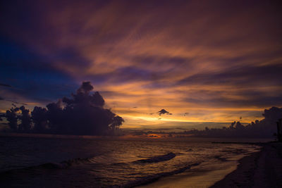 Scenic view of beach against sky during sunset