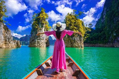 Asian woman standing on boat in ratchaprapha dam khao sok national park at suratthani,thailand