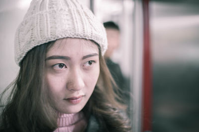 Close-up of thoughtful young woman in train