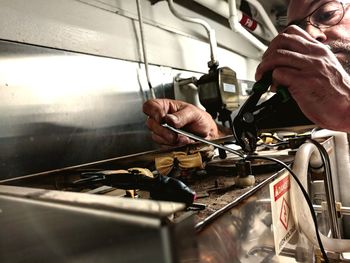 Mature man repairing electronic equipment