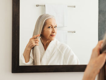 Portrait of young woman using mobile phone