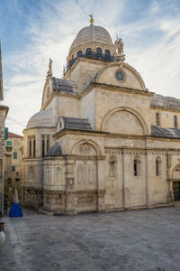 Cathedral of building against cloudy sky