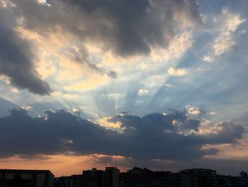 Silhouette buildings against sky during sunset