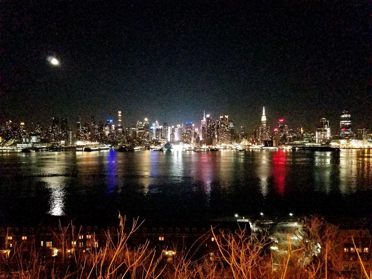 night, water, reflection, city, illuminated, architecture, sky, building exterior, cityscape, river, built structure, outdoors, travel destinations, nature, no people, urban skyline, skyscraper