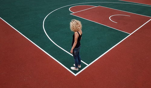 High angle view of woman standing on outdoor sports court