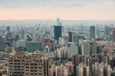 Aerial view of modern buildings in city against sky