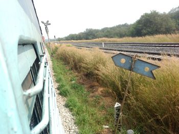 Train on field against clear sky