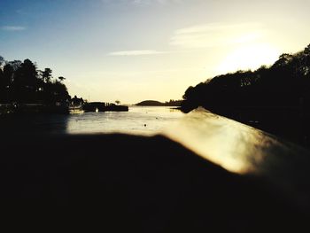 Scenic view of river against sky at sunset