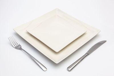 High angle view of empty plate against white background