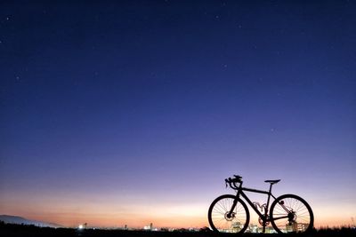 Bicycle against clear sky at night