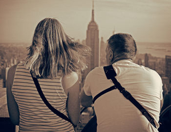 Rear view of friends looking at city