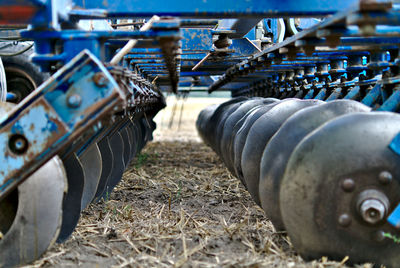 Close-up of agricultural machinery on field