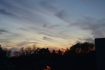 Silhouette of trees against sky at sunset