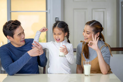 Friends and son on table