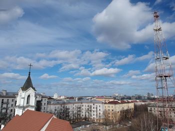 Panoramic view of buildings in town against sky