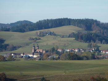 Houses on field against sky