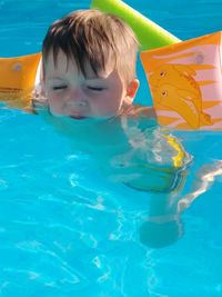 Cute boy swimming in pool