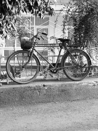 Bicycle parked against building