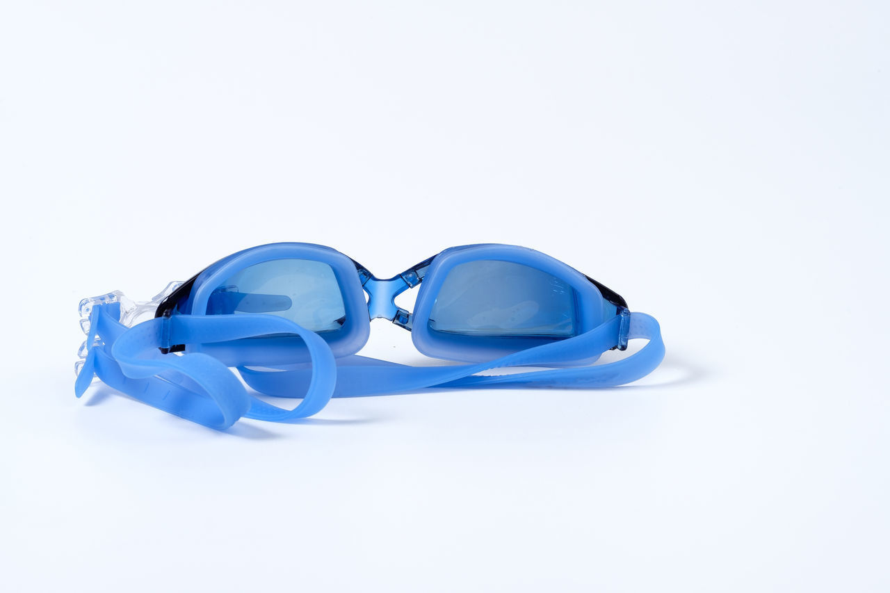 CLOSE-UP OF SUNGLASSES ON BLUE BACKGROUND