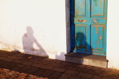 Shadow of man on door of building