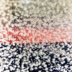 Full frame shot of raindrops on window