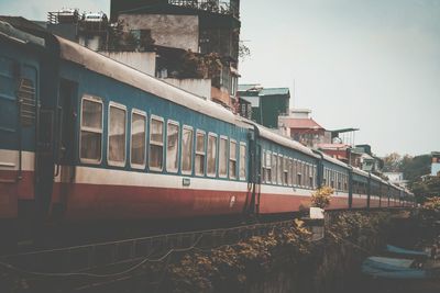 Train by buildings in city