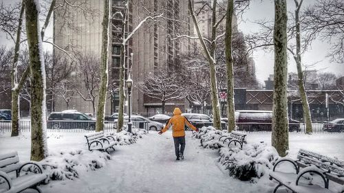 Man walking on snow covered landscape