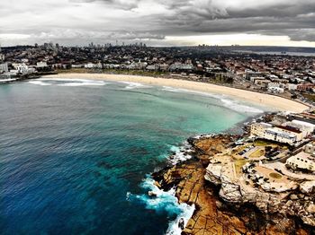 High angle view of sea and buildings against sky