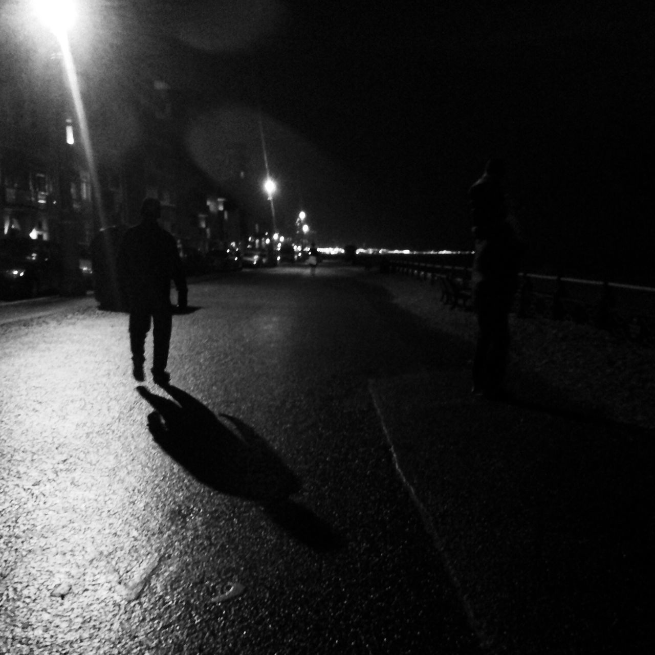 night, full length, illuminated, walking, lifestyles, street, men, leisure activity, rear view, road, city life, city, person, street light, on the move, the way forward, silhouette