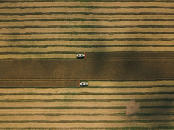 Aerial view of machinery working in agricultural field