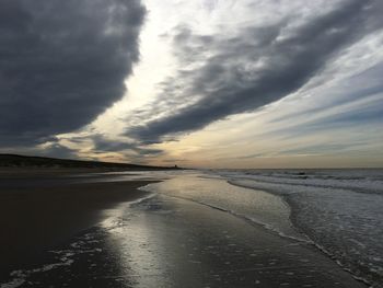 Scenic view of beach against sky during sunset