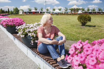 Full length of woman sitting at park